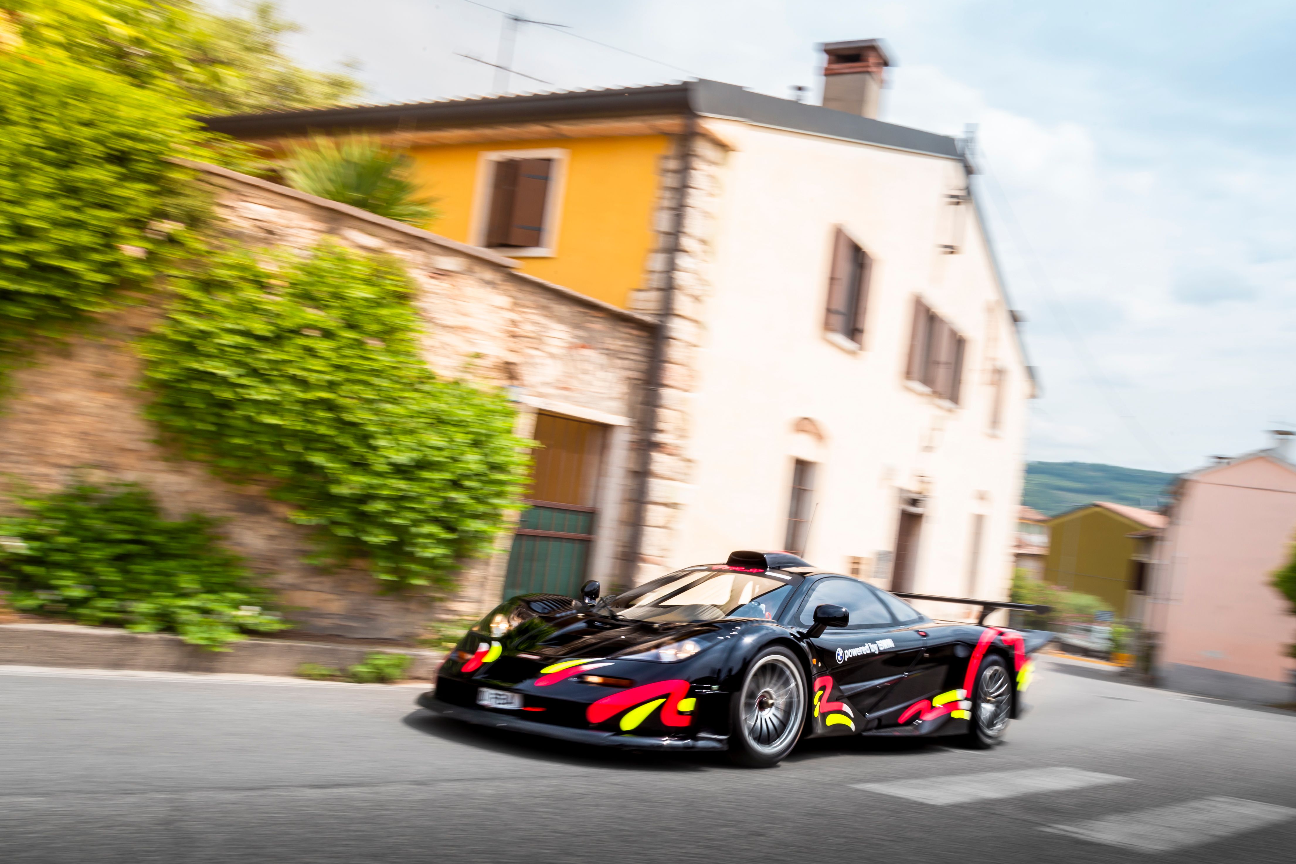 Black McLaren F1 GTR driving through an Italian village